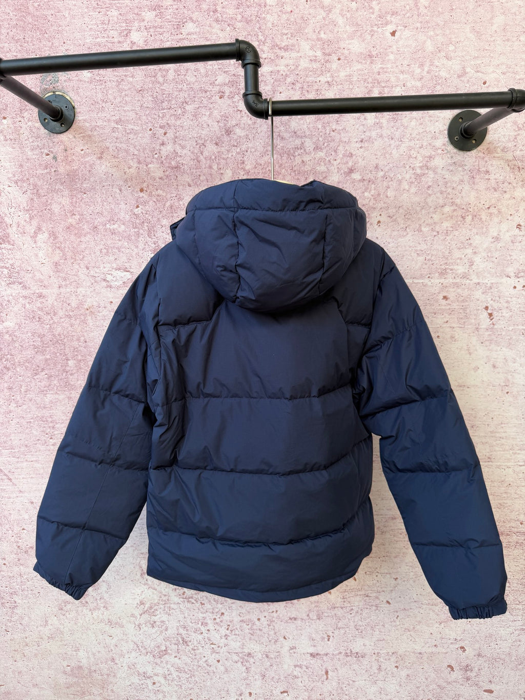 Navy hooded puffer jacket with full-zip front and padded shoulders