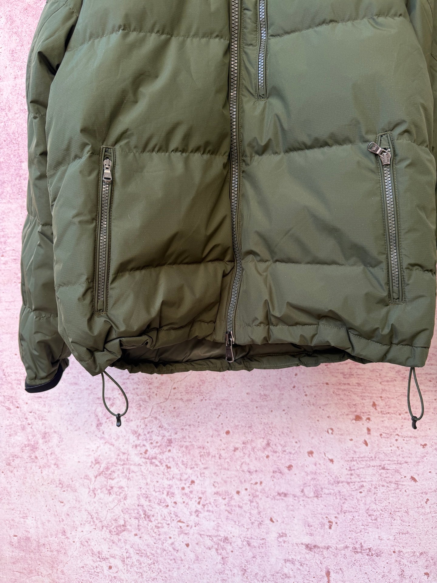 Olive puffer jacket with full zipper and quilted front panel