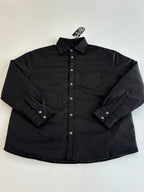 Black long-sleeve button-up jacket with pointed collar and chest pocket details