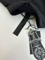 Black jacket tag and drawstring label attached to the garment