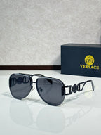 Versace sunglasses with dark frame, gold hinges, and dark lenses