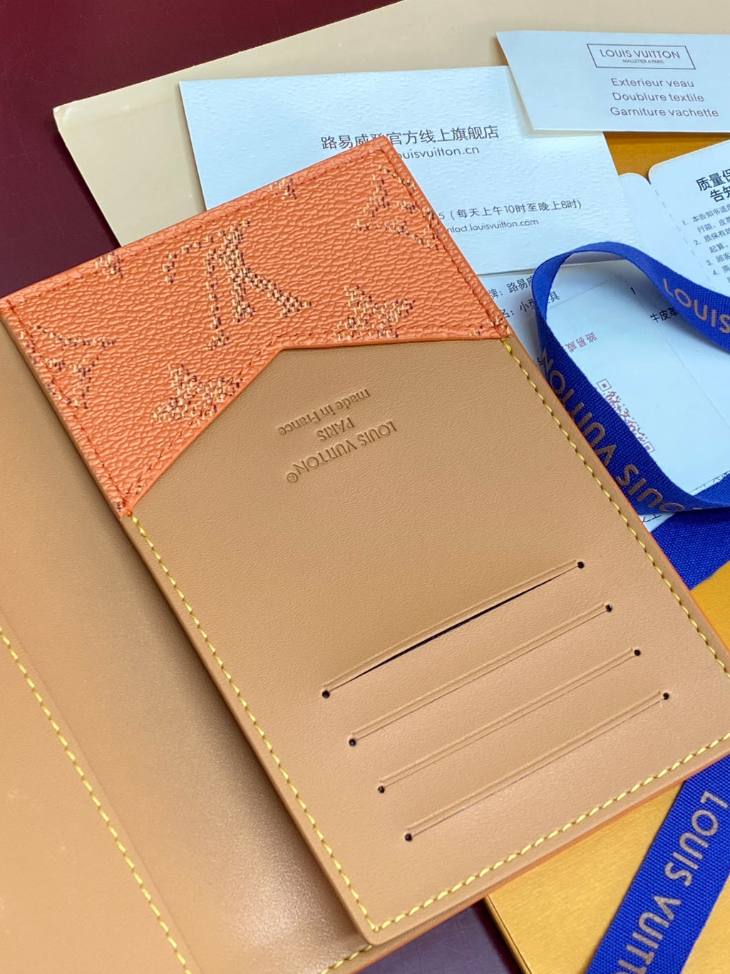 Small Louis Vuitton bag open, beige card holder with visible stitchwork