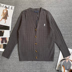 Dark gray cable-knit cardigan sweater with V-neck and gold button placket