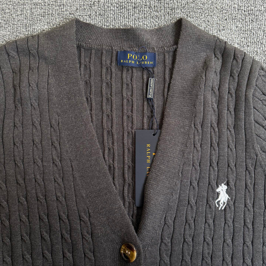 Dark gray cable-knit cardigan close-up with Polo Ralph Lauren patch, buttons, horse logo