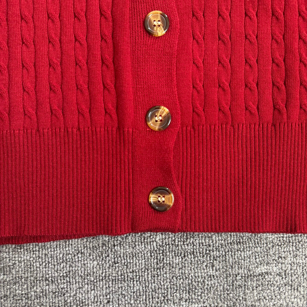Red cable-knit cardigan front with gold tone button details