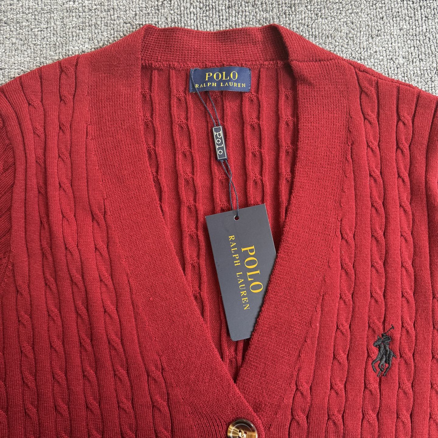 Red cable-knit V-neck cardigan with Polo Ralph Lauren tag and button placket