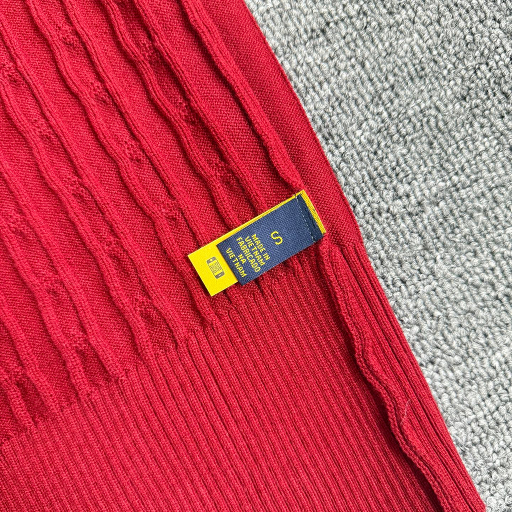 Red cable-knit cardigan inner neck label on sleeve