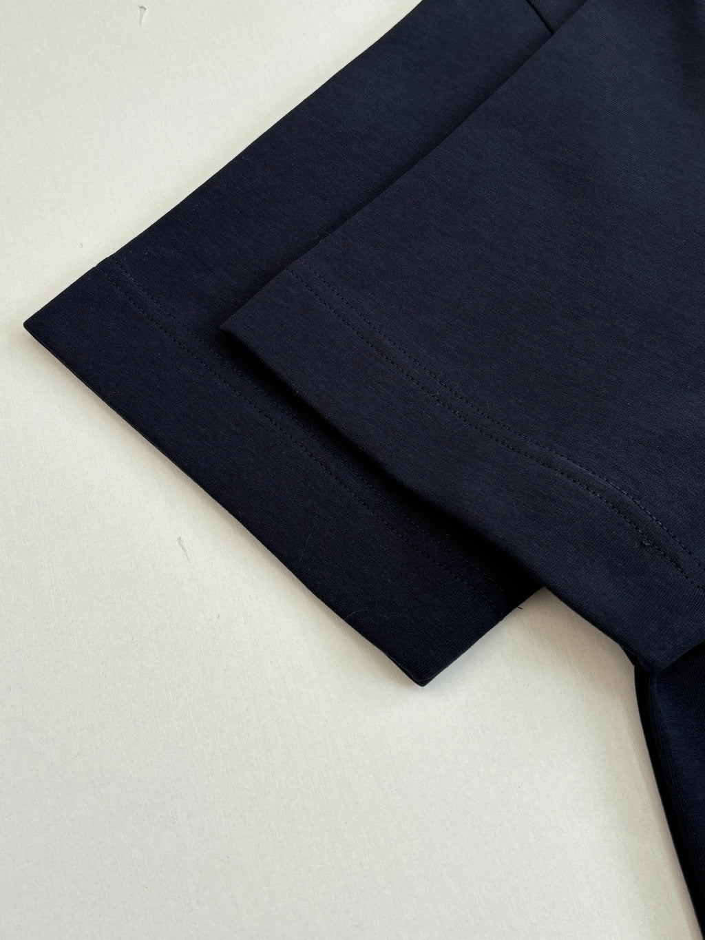 Fendi short-sleeve T-shirt in dark navy, close-up of sleeve hem detail