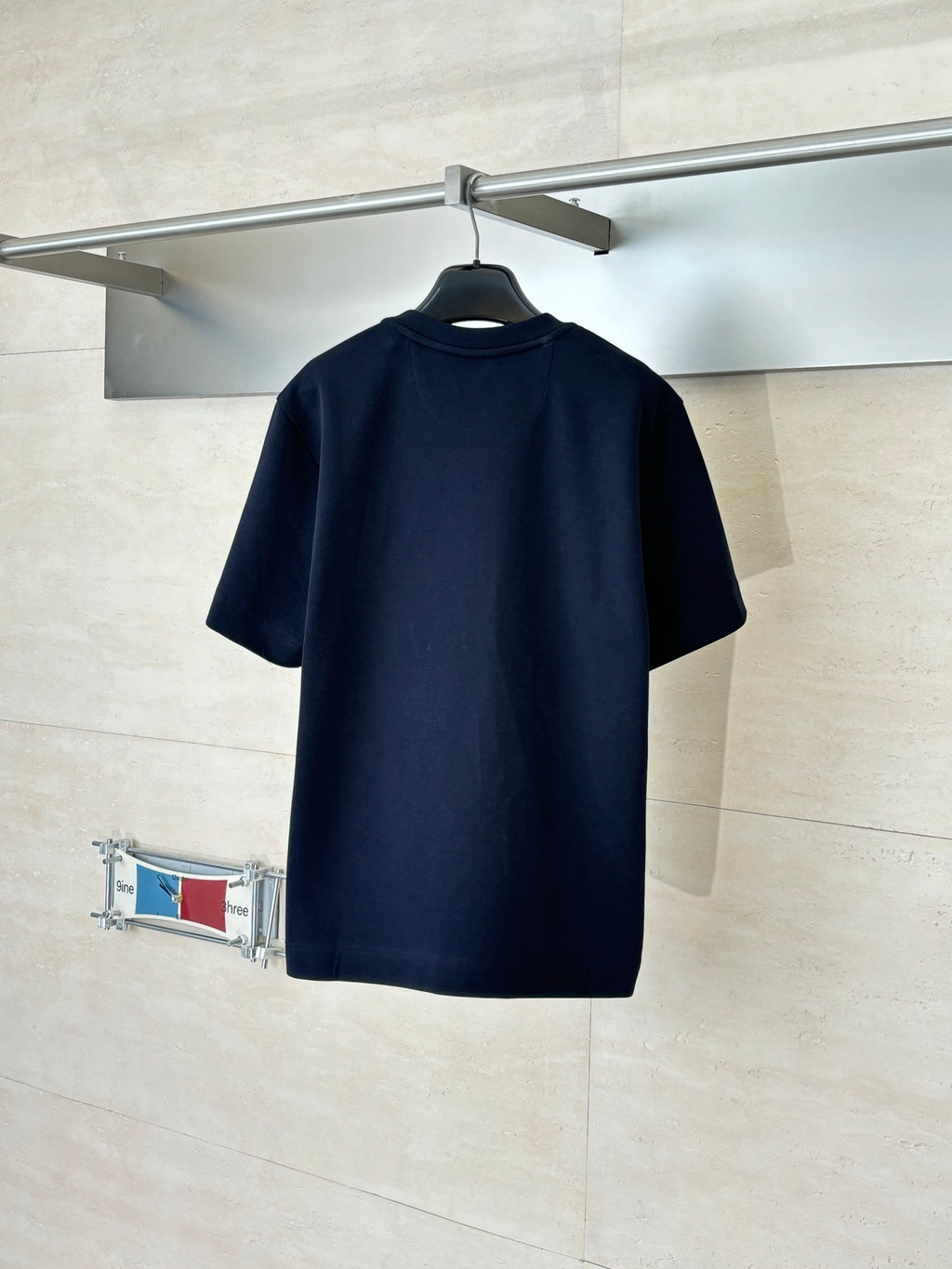 Fendi short-sleeve T-shirt in dark navy, back view on hanger