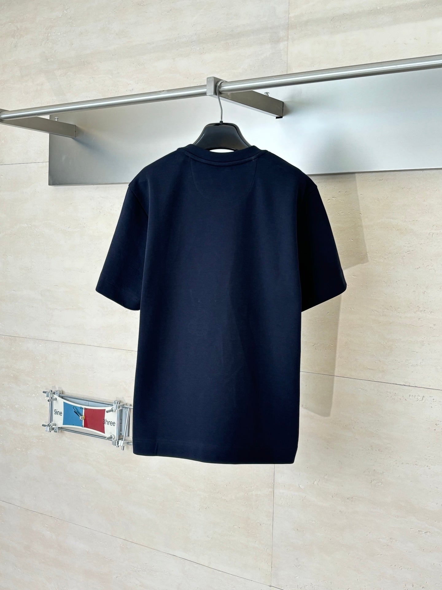 Fendi short-sleeve T-shirt in dark navy, back view on hanger
