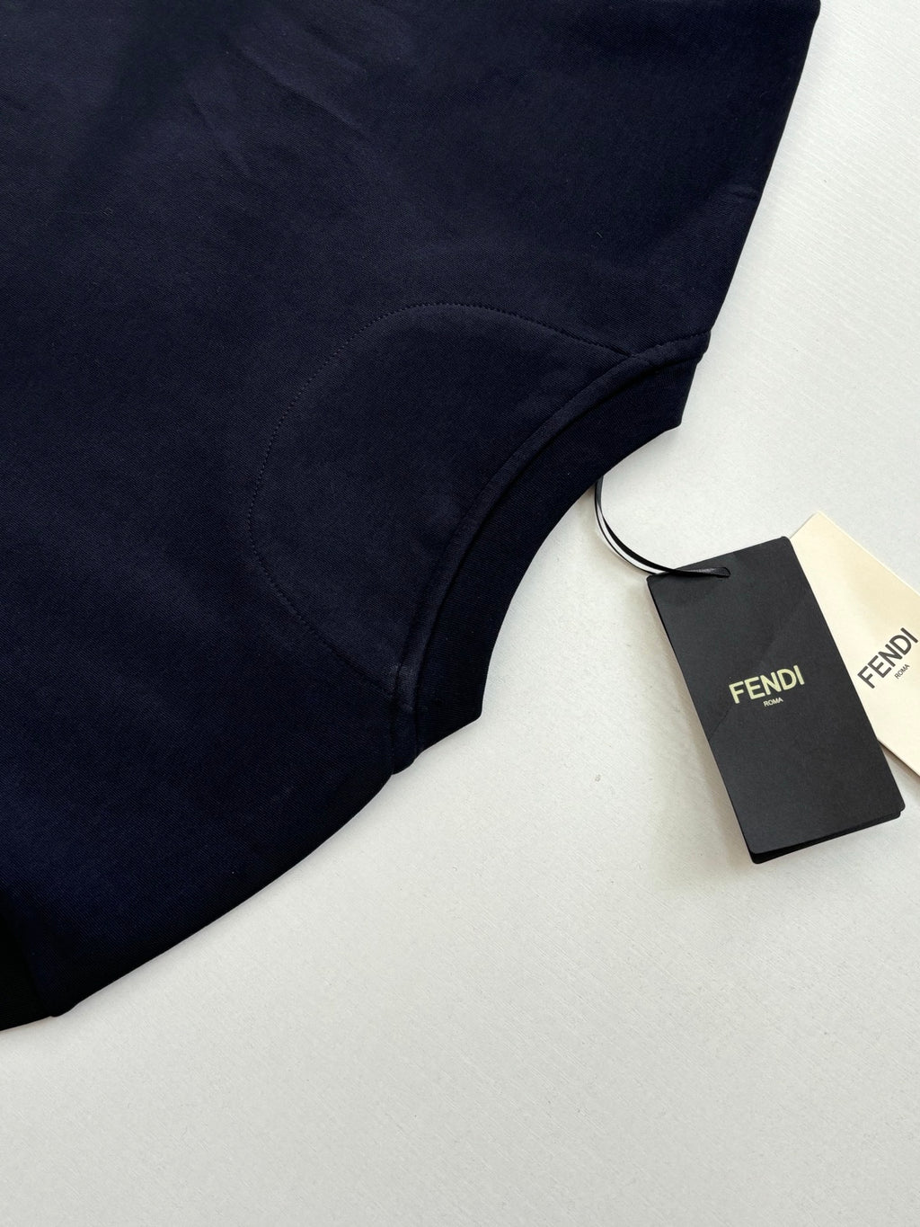 Fendi short-sleeve T-shirt in dark navy with Fendi tag, angled close-up