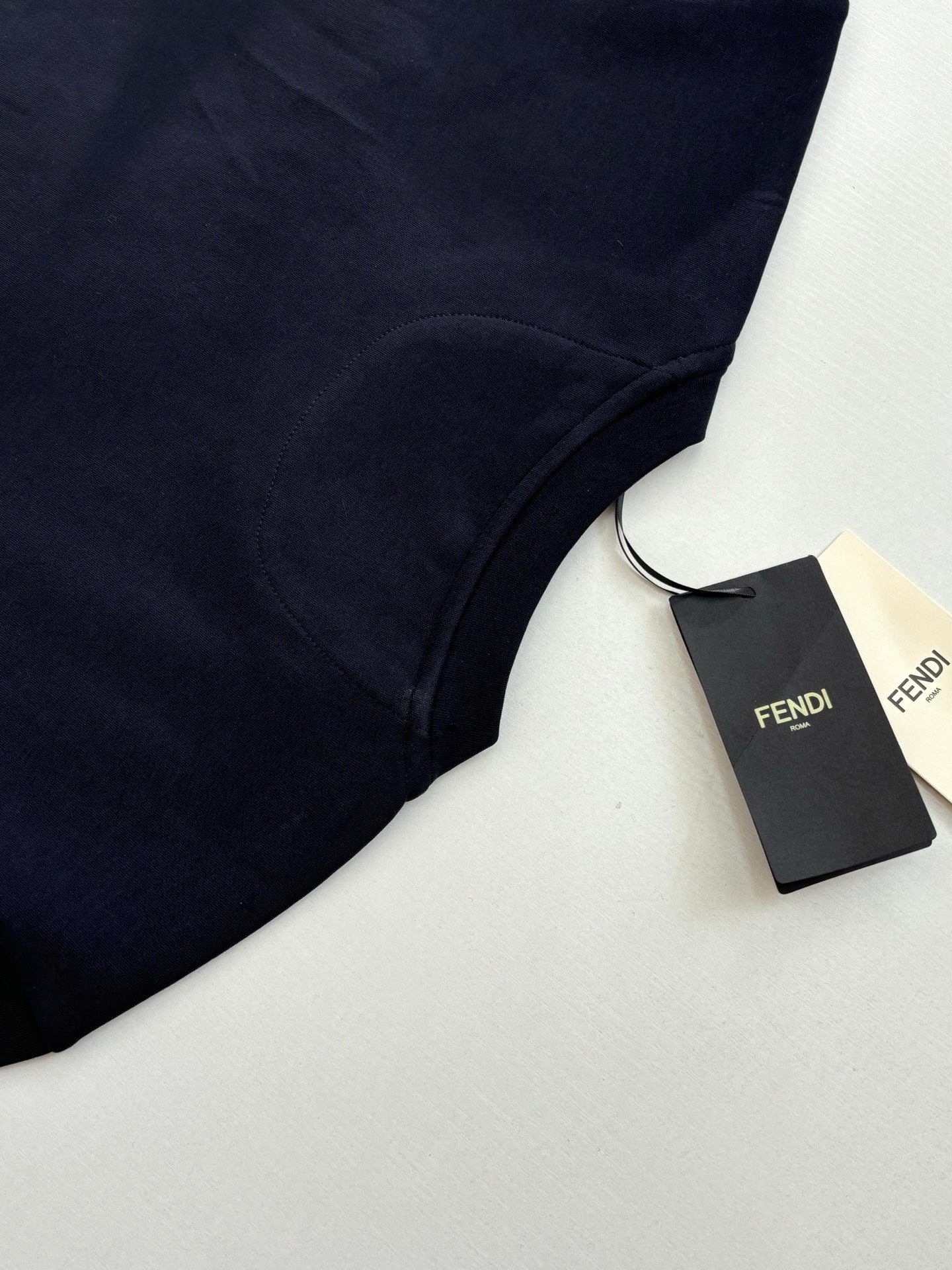 Fendi short-sleeve T-shirt in dark navy with Fendi tag, angled close-up