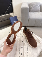 Dior unisex sneakers shown with outsoles visible: brown with white patterned tread