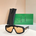 Bottega Veneta sunglasses with dark tortoiseshell frame and amber-tinted lenses, black case