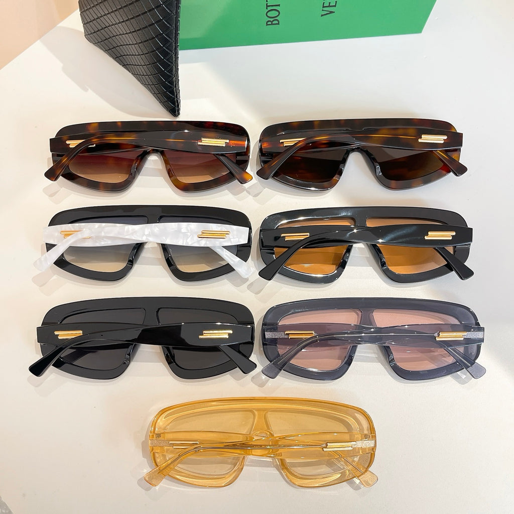 Bottega Veneta sunglasses set shown in top view with varied frames, plus black case