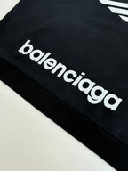 Balenciaga top with white 'balenciaga' logo lettering on black sleeve