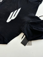 Balenciaga black hoodie sleeve with white emblem and hang tag, zip close-up