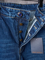 Louis Vuitton blue denim pants close-up of button fly, coin pocket, and tags