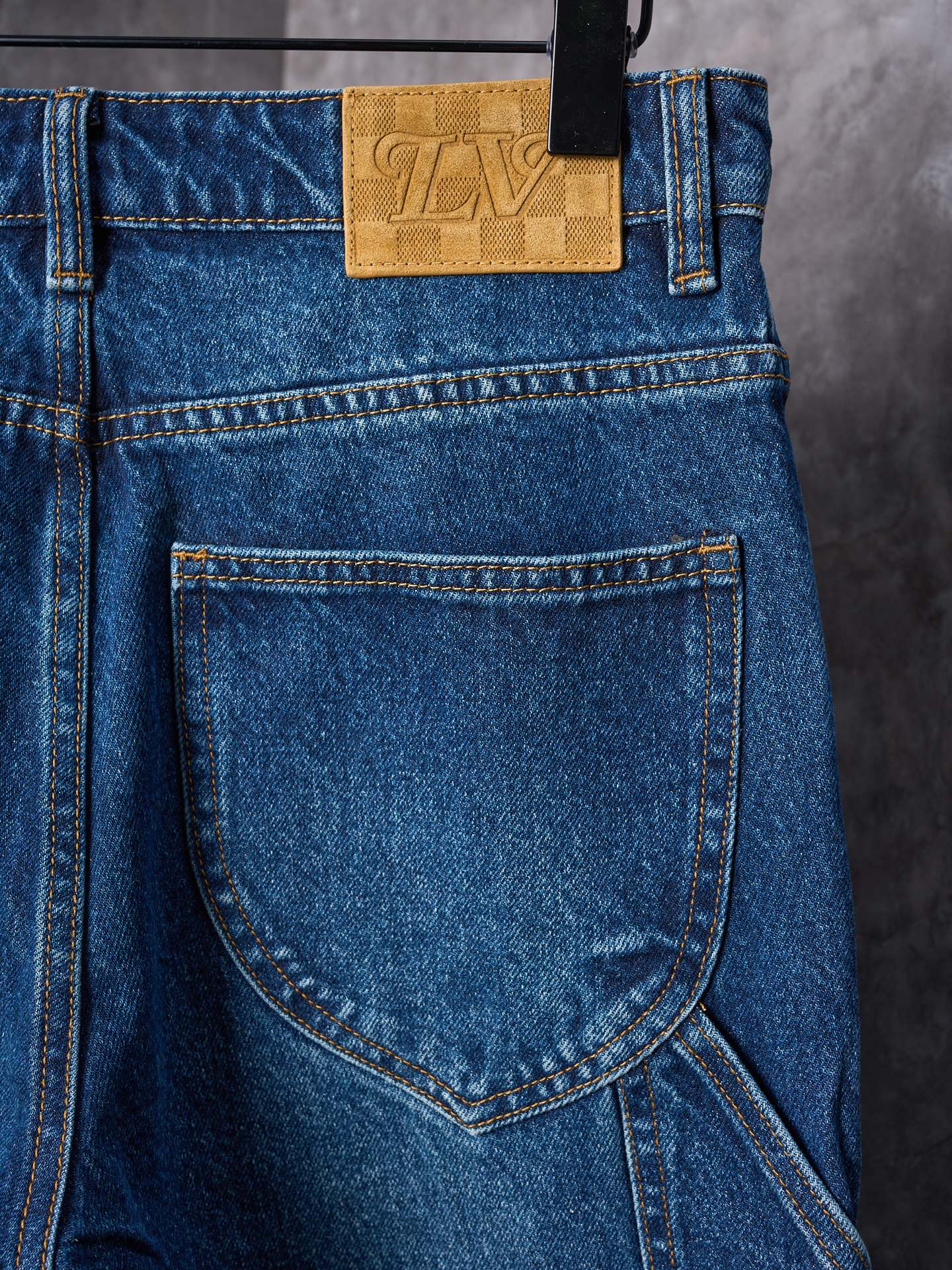 Louis Vuitton blue denim pants close-up of waistband label and front pocket