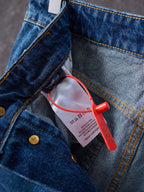 Louis Vuitton blue denim pants close-up of pocket edge and red security tag