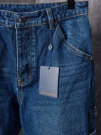 Louis Vuitton blue denim pants close-up of front buttons and inner tag
