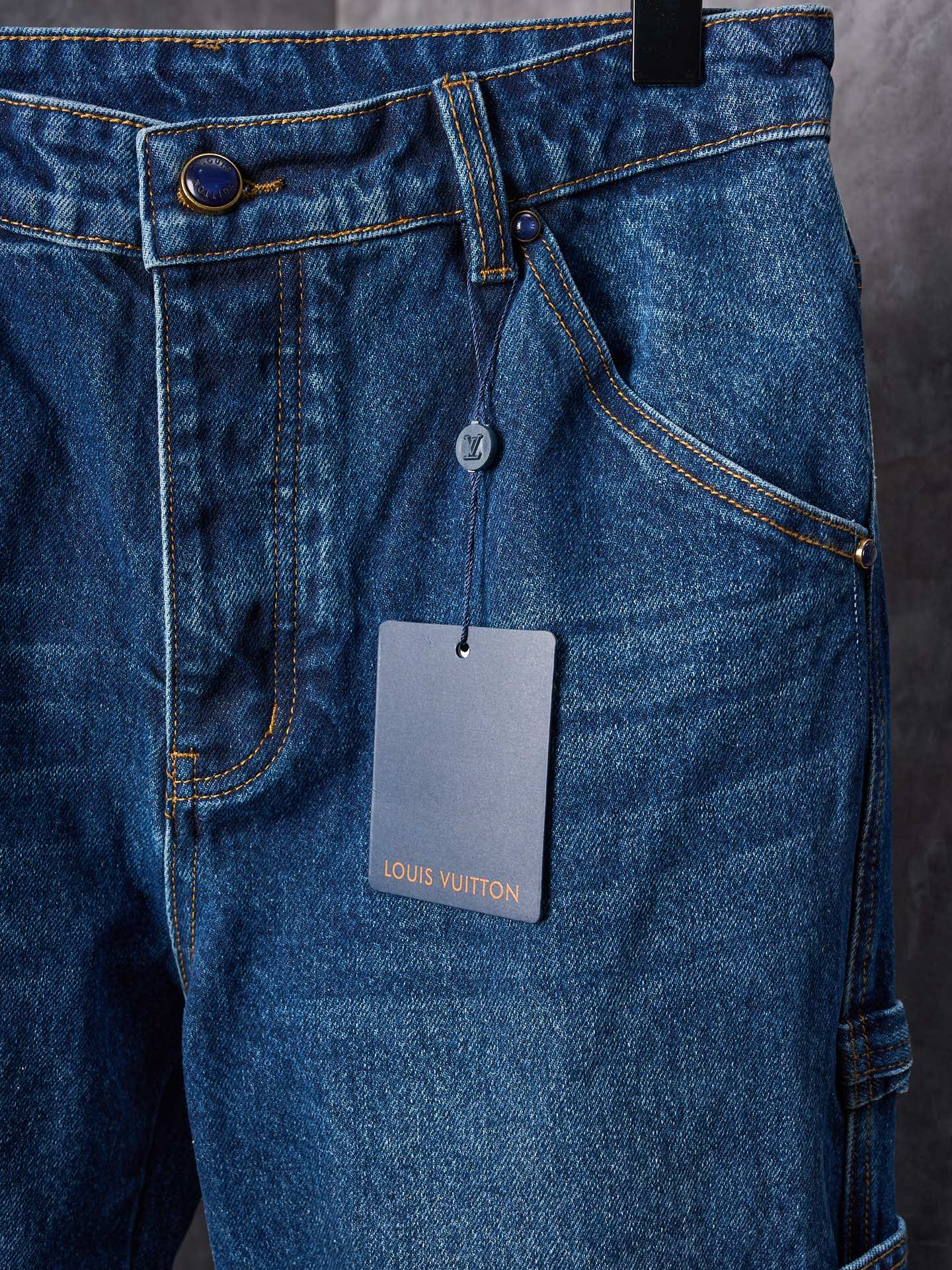 Louis Vuitton blue denim pants close-up of front buttons and inner tag