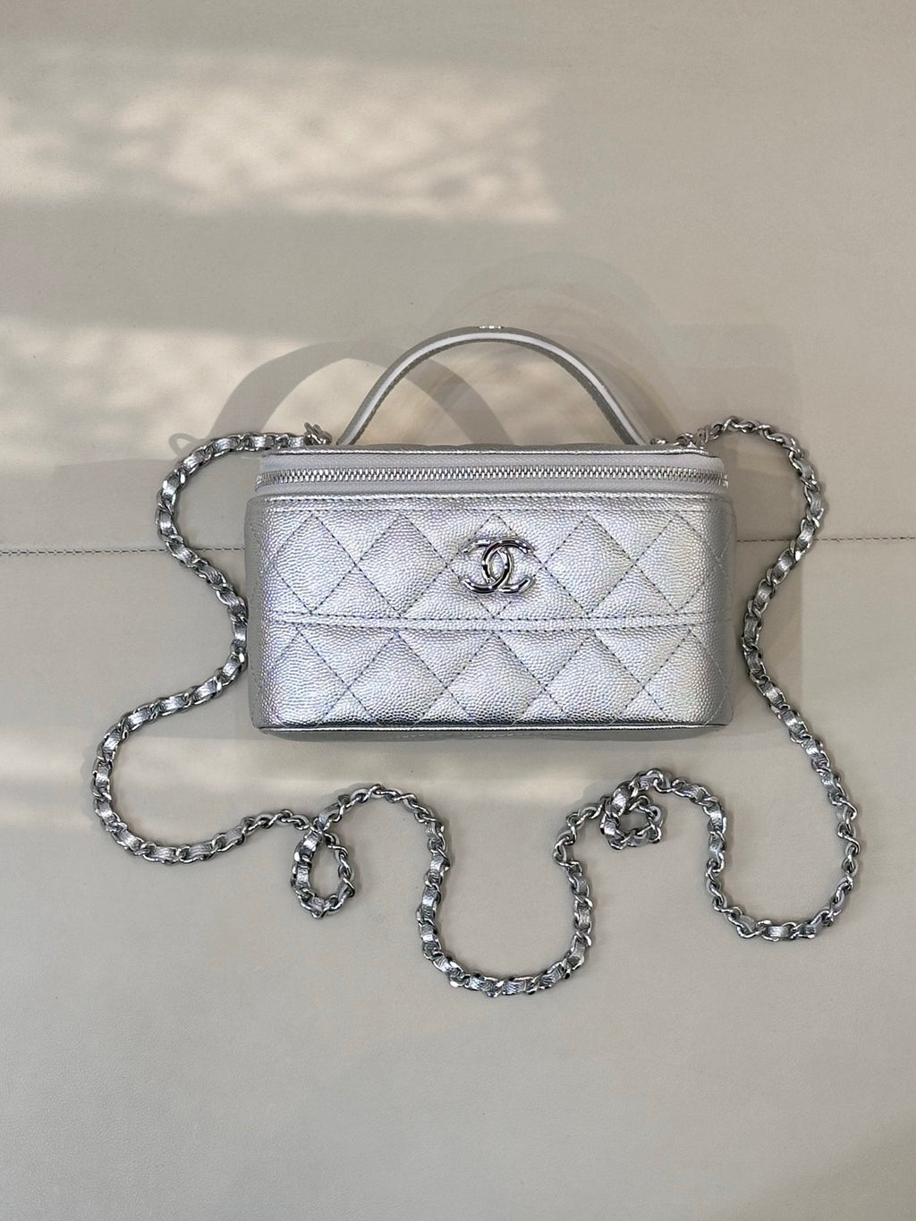 Quilted mini handbag with top handle and silver-tone chain strap, front flap with logo