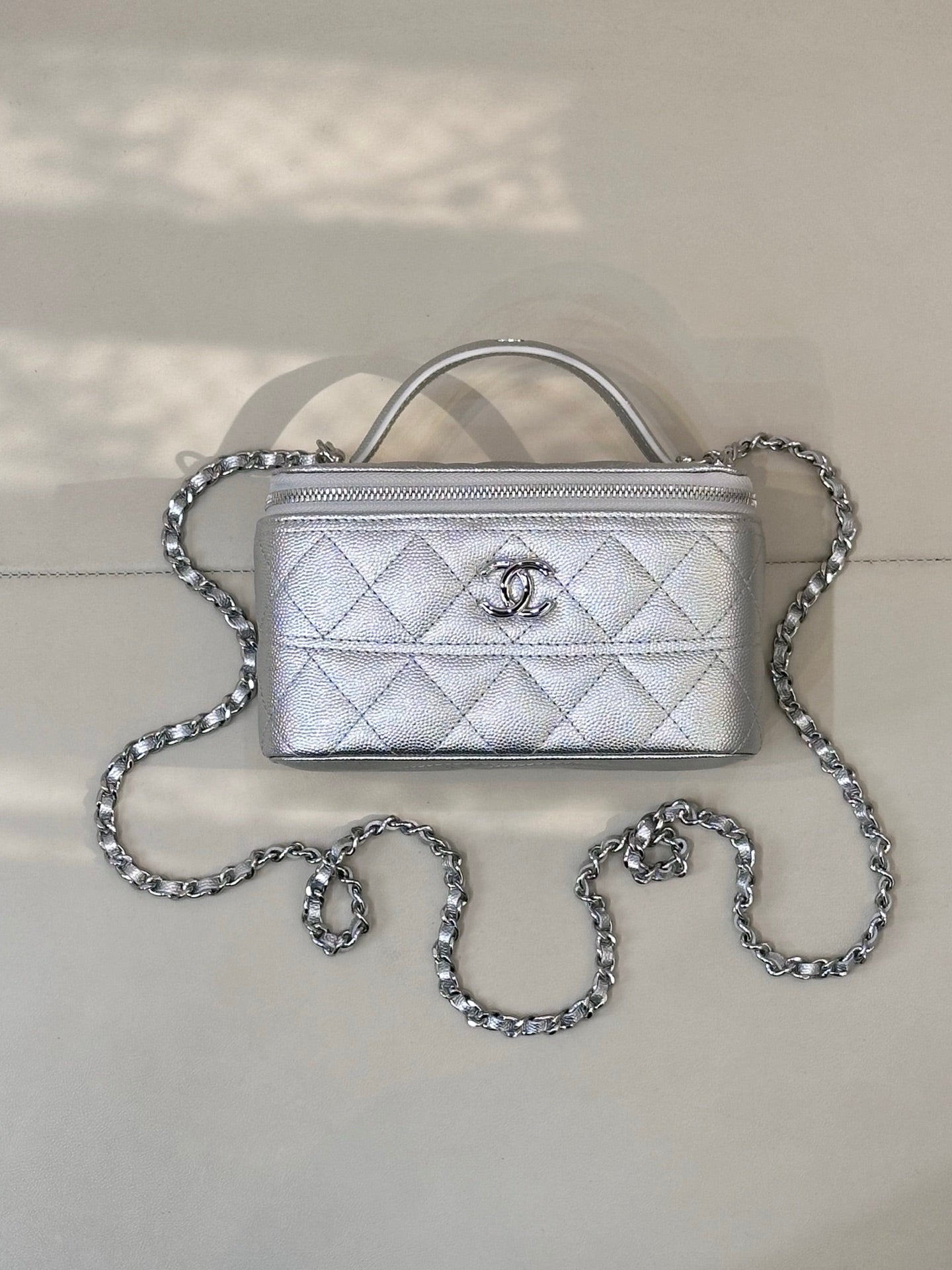 Quilted mini handbag with top handle and silver-tone chain strap, front flap with logo