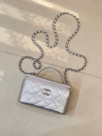 Quilted mini handbag with silver-tone chain shoulder strap and top handle, front logo emblem