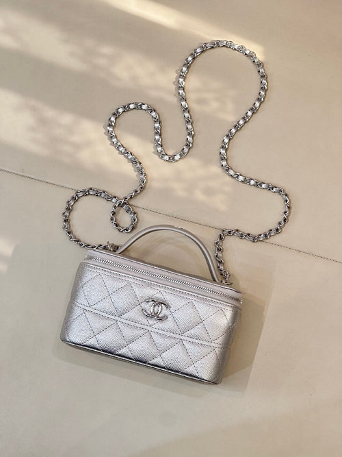 Quilted mini handbag with silver-tone chain shoulder strap and top handle, front logo emblem