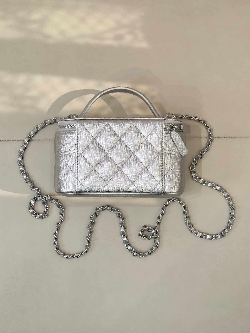 Quilted mini handbag with front flap and silver-tone chain strap, top handle and side hardware