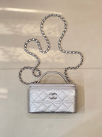 Quilted mini handbag with silver-tone chain strap and top handle, front logo clasp detail