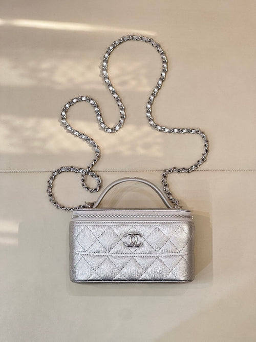 Quilted mini handbag with silver-tone chain strap and top handle, front logo clasp detail