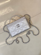 Quilted mini handbag in light silver with top handle and chain strap, front flap logo