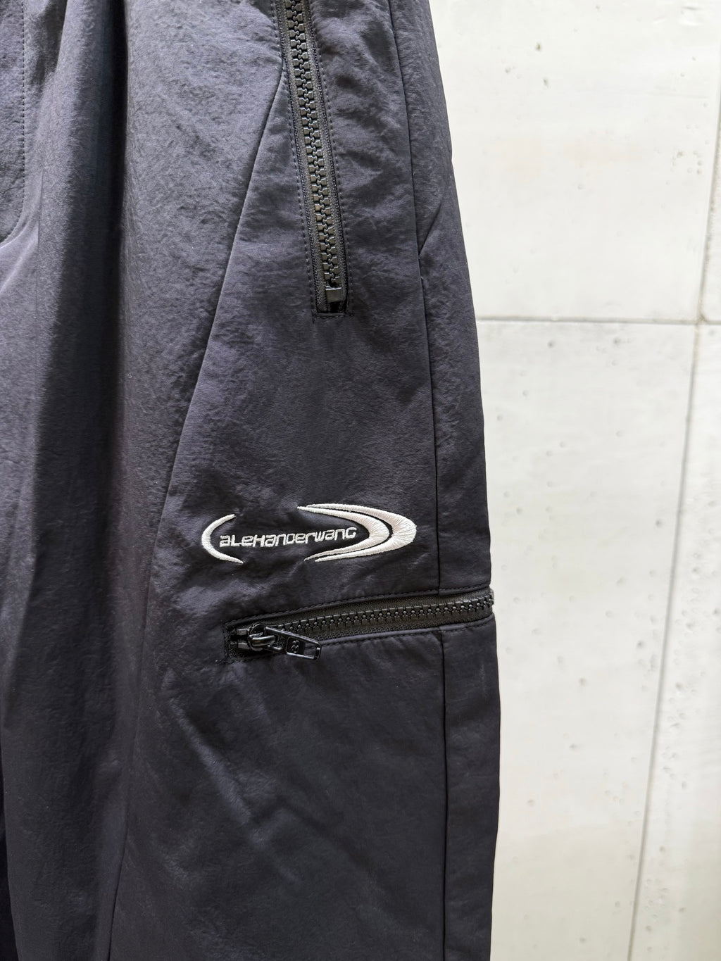 Balenciaga dark pants with side zipper pocket and oval logo patch