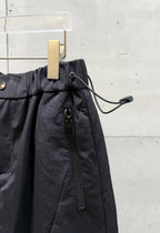 Balenciaga dark pants with drawstring cord detail and front zipper pocket
