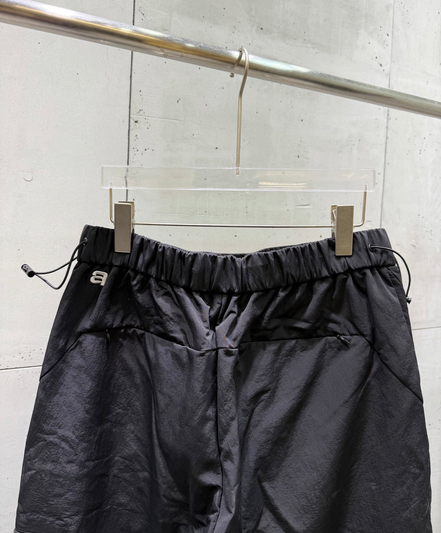 Balenciaga dark pants with elastic waistband, drawstring ties, and front gathers