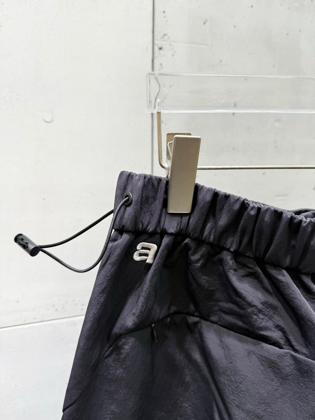 Black drawstring-waist pants with small alexanderwang logo