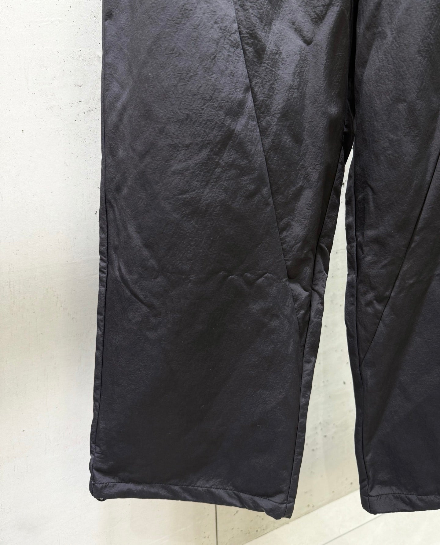 Balenciaga dark pants with stitched seam details and roomy leg opening