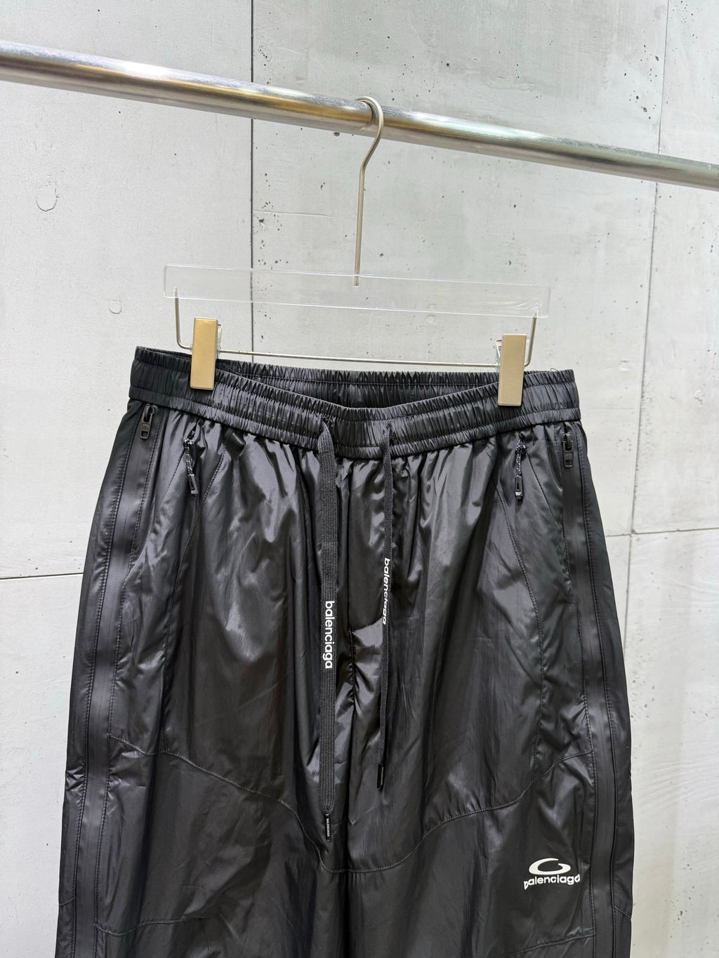 Balenciaga black pants with elastic waistband, front drawstring, and side zip pockets