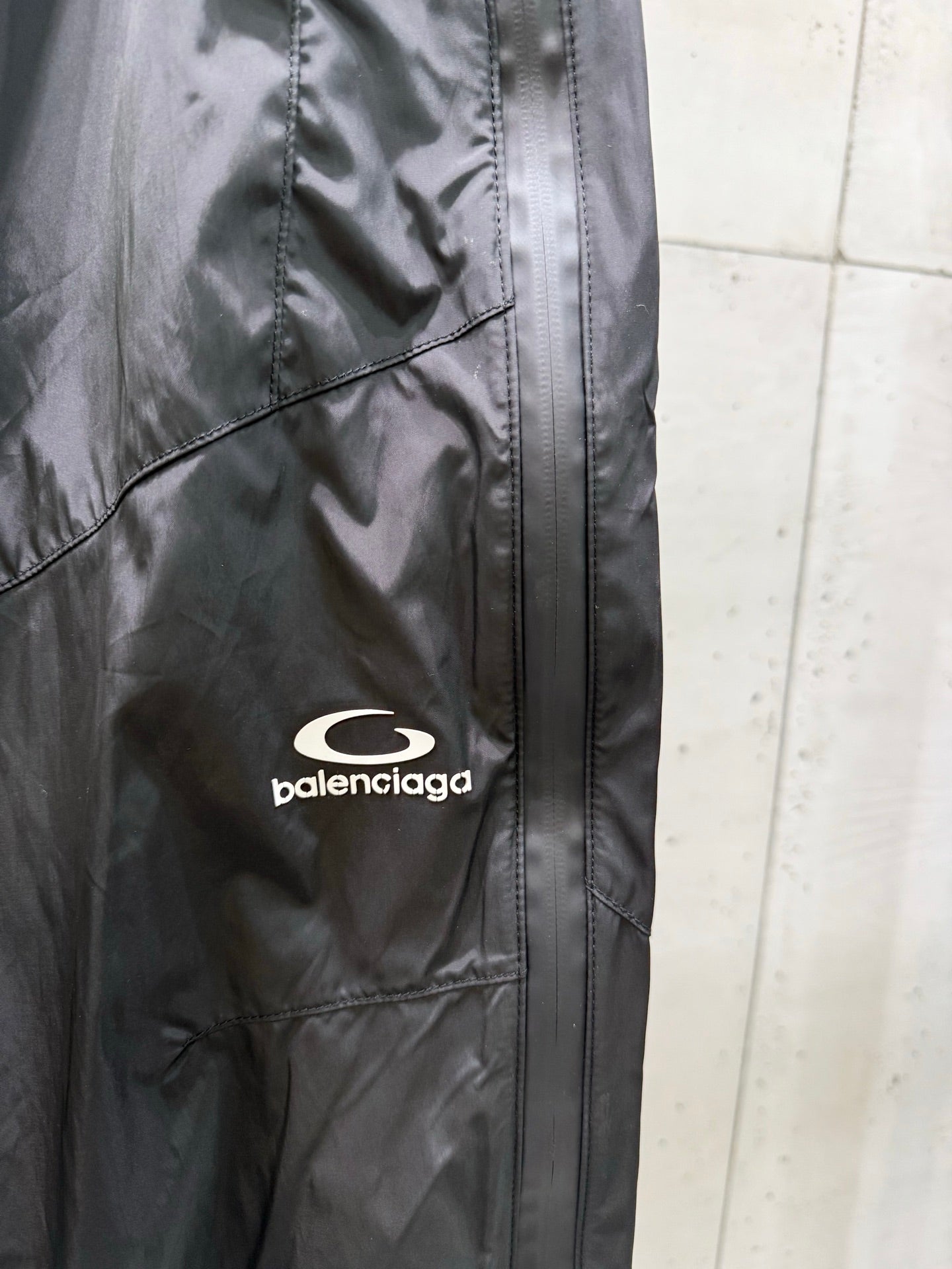 Balenciaga black cargo-style pants with front seam and embroidered logo patch