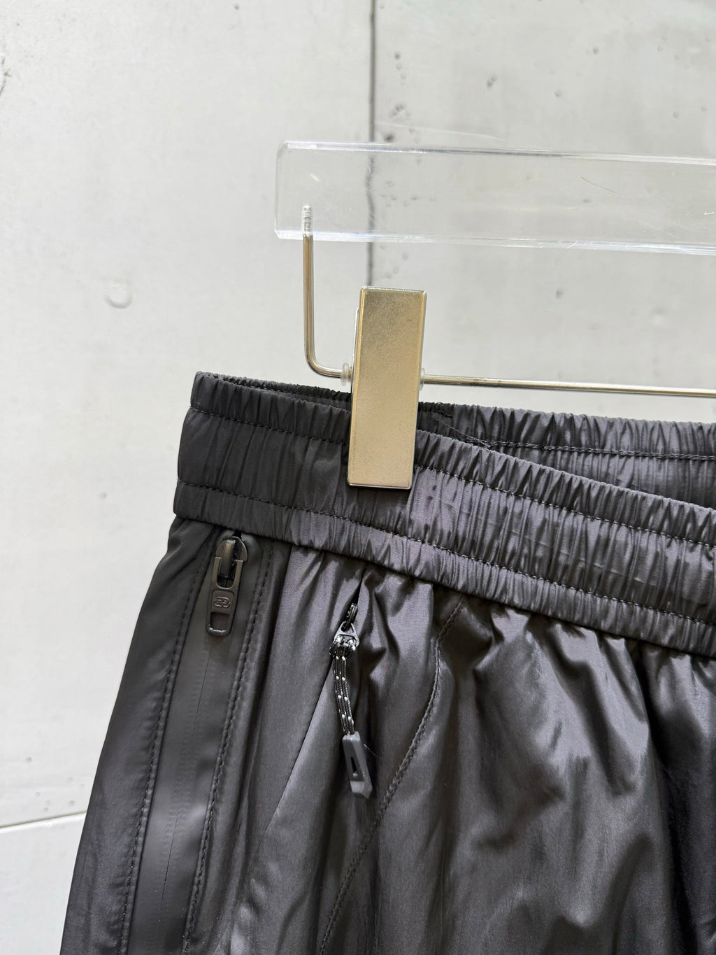 Balenciaga black pants waistband close-up with adjustable drawstring and belt loops