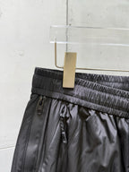 Balenciaga black pants waistband close-up with adjustable drawstring and belt loops