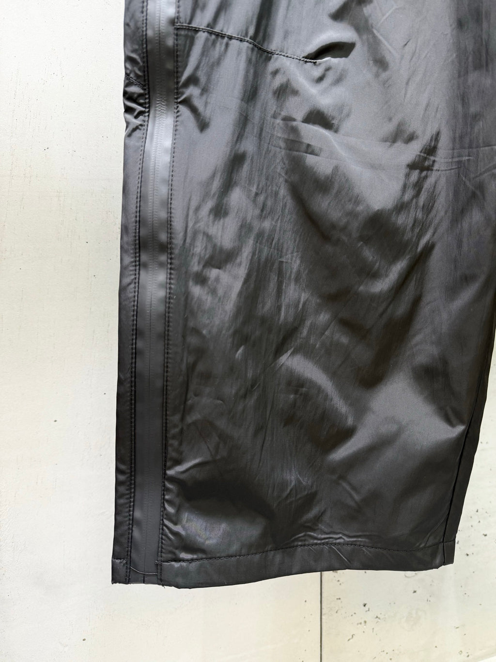 Balenciaga black pants side view with zipper pocket and stitched vertical seams