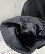 Dark pants interior with drawstring knot and stitched waistband