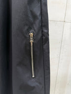 Dark pants with side zipper pocket and gold chain pull