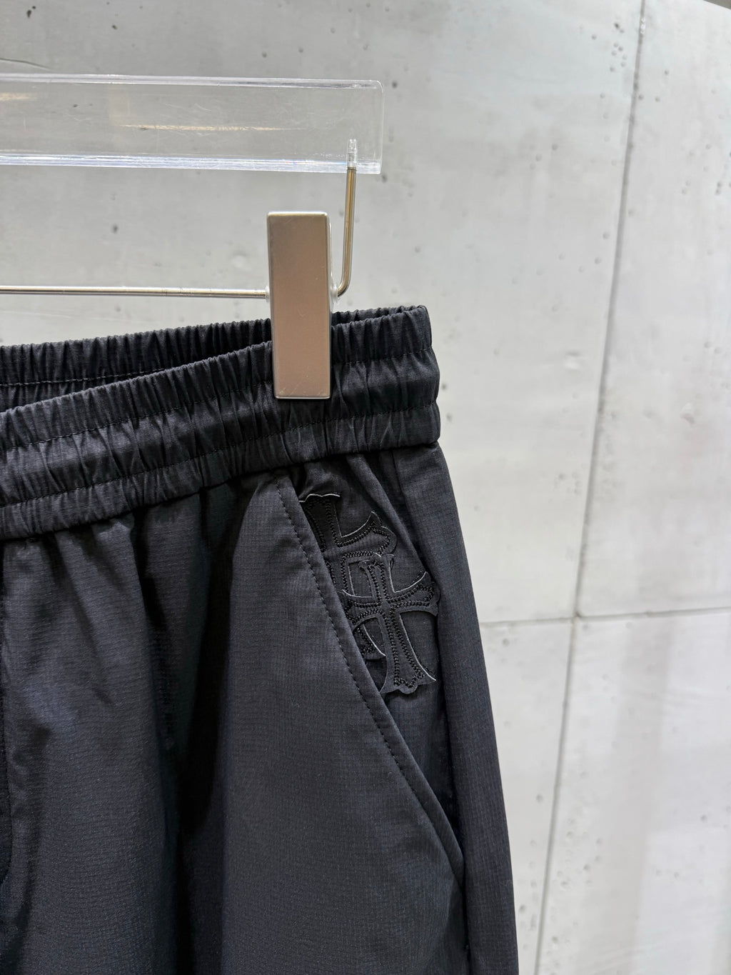 Dark pants elastic waistband with inner pocket and embossed trim