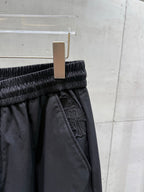 Dark pants elastic waistband with inner pocket and embossed trim