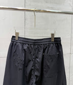 Chrome pants front view with elastic waist, side pocket, and dark wide-leg silhouette.