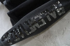 Black sleeve with distressed white lettering graphic, long cuff.